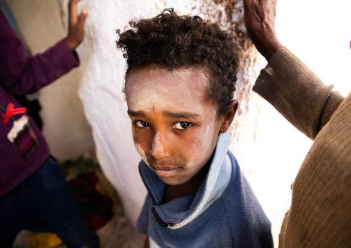 Oromo pilgrim boy in Sheikh Hussein shrine with jarawa powder on the face, Oromia, Sheik Hussein, Ethiopia