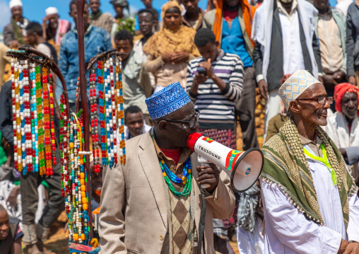 Sufi leader in front of a oulle forket stick decorated with necklaces and prayerbeads, Oromia, Sheik Hussein, Ethiopia