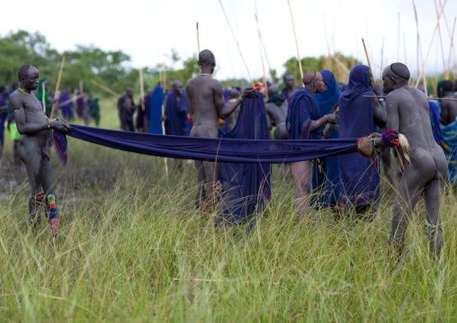 Suri tribe warriors fighting during a donga stick ritual, Omo valley, Tulgit, Ethiopia