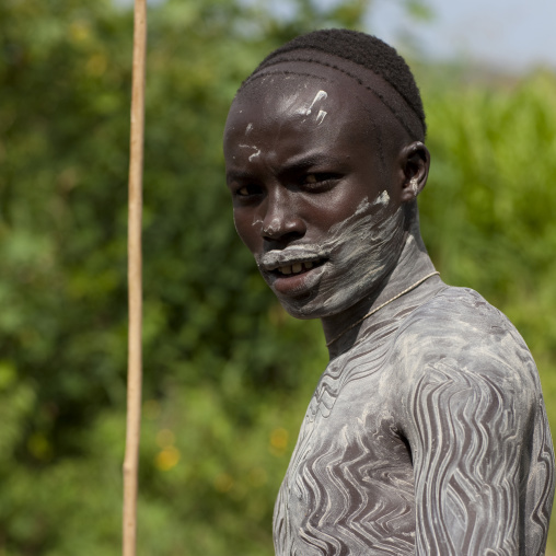 Surma warrior with clay body paintings, Turgit village, Omo valley, Ethiopia