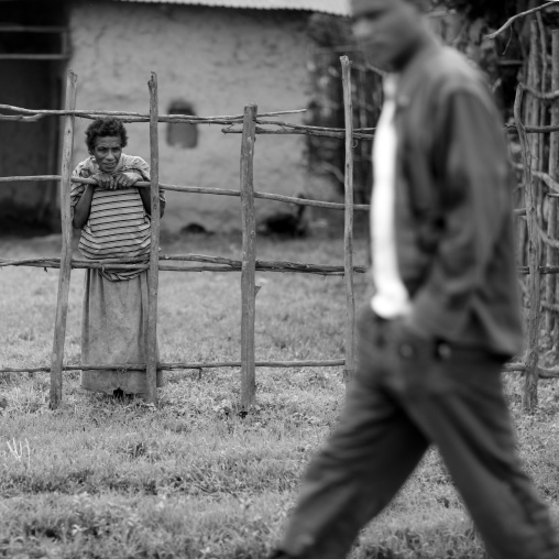 Woman looking at a man passing by, Mezan teferi area, Ethiopia