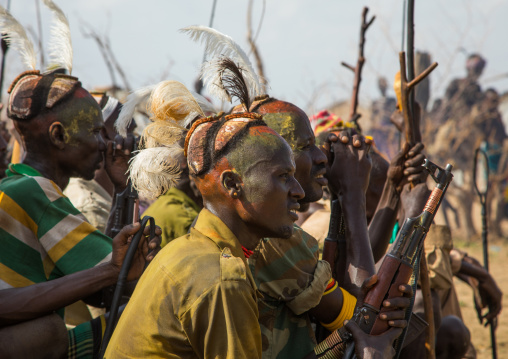 Tribe warriors during the proud ox ceremony in the Dassanech tribe waiting to share the cow meat, Turkana County, Omorate, Ethiopia