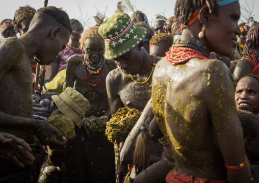 People covering themselves with cow dungs during the proud ox ceremony in the Dassanech tribe, Turkana County, Omorate, Ethiopia