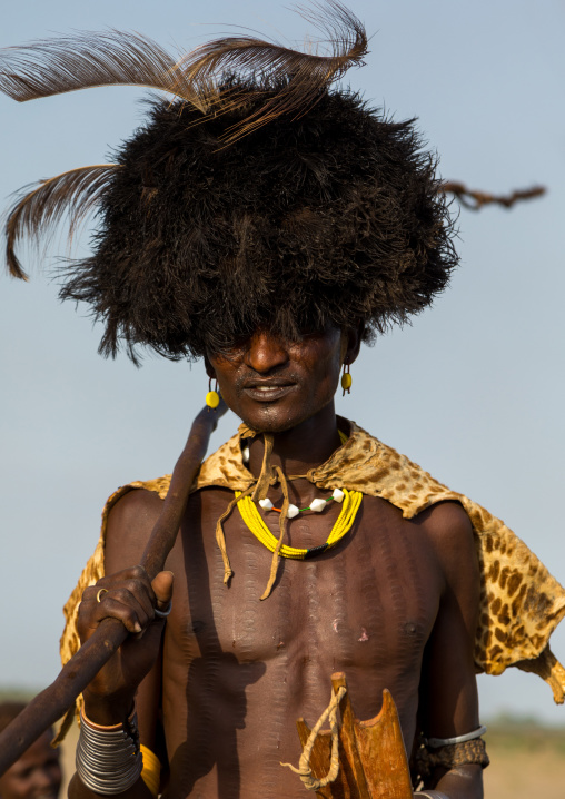 Dassanech men with leopard skins and ostrich feathers wigs during Dimi ceremony to celebrate circumcision of teenagers, Turkana County, Omorate, Ethiopia