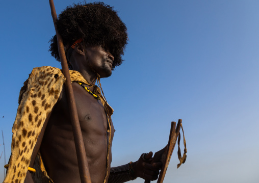 Dassanech men with leopard skins and ostrich feathers wigs during Dimi ceremony to celebrate circumcision of teenagers, Turkana County, Omorate, Ethiopia