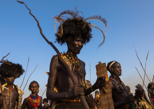 Dassanech men with leopard skins and ostrich feathers wigs during Dimi ceremony to celebrate circumcision of teenagers, Turkana County, Omorate, Ethiopia