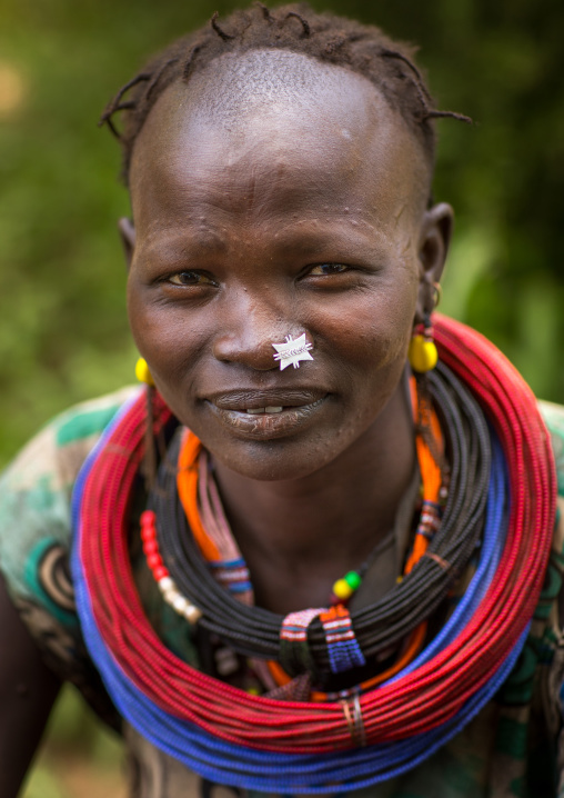 Portrait of a sudanese Toposa tribe woman refugee with huge necklaces and nose decoration, Omo Valley, Kangate, Ethiopia