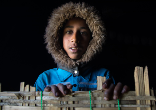 Gurage tribe boy with a rain hood in a house, Gurage Zone, Butajira, Ethiopia