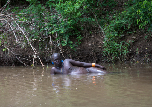 Bodi tribe fat man taking a bath before the Kael ceremony, Omo valley, Hana Mursi, Ethiopia