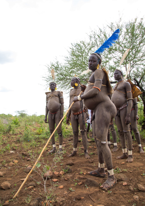 Bodi tribe fat men resting during Kael ceremony, Omo valley, Hana Mursi, Ethiopia