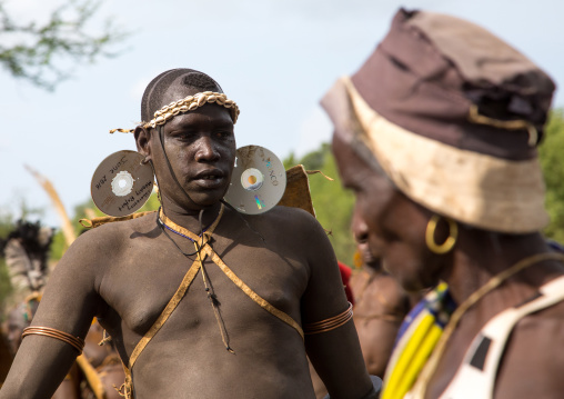 Bodi tribe fat man with a dvd as earrings during Kael ceremony, Omo valley, Hana Mursi, Ethiopia