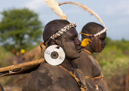 Bodi tribe fat man with cd as earrings during Kael ceremony, Omo valley, Hana Mursi, Ethiopia