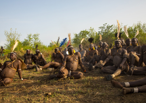 Bodi tribe fat men resting during Kael ceremony, Omo valley, Hana Mursi, Ethiopia