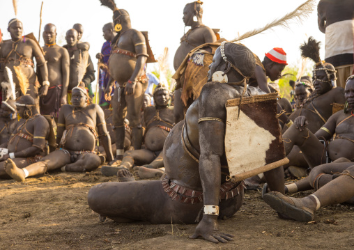 Bodi tribe fat men resting during Kael ceremony, Omo valley, Hana Mursi, Ethiopia