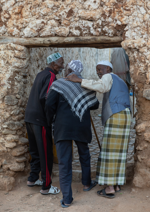 Old men walking through the old walls of the town, Harari Region, Harar, Ethiopia