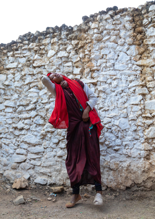Sufi woman with a red veil into trance during a muslim ceremony, Harari Region, Harar, Ethiopia