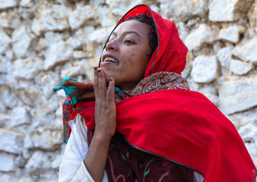 Sufi woman with a red veil into trance during a muslim ceremony, Harari Region, Harar, Ethiopia