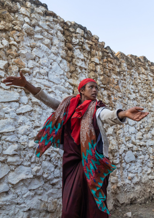 Sufi woman with a red veil into trance during a muslim ceremony, Harari Region, Harar, Ethiopia