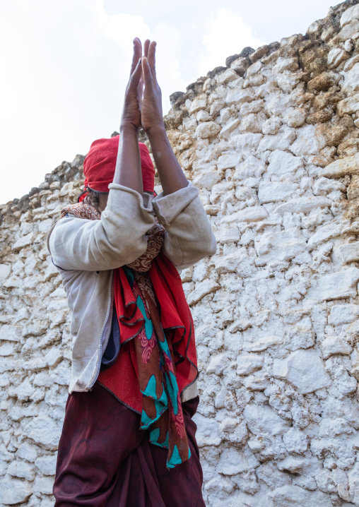 Sufi woman with a red veil into trance during a muslim ceremony, Harari Region, Harar, Ethiopia