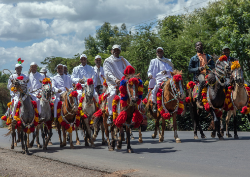 Ethiopian men riding horses on a road during an oromo liberation front party celebration, Oromia, Waliso, Ethiopia