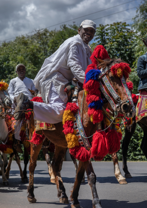 Ethiopian men riding horses on a road during an oromo liberation front party celebration, Oromia, Waliso, Ethiopia