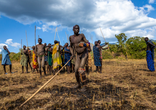 Suri tribe warriors parading before a donga stick fighting ritual, Omo valley, Kibish, Ethiopia