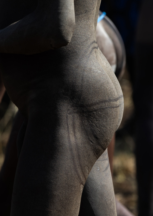 Naked suri tribe warriors make-up during a donga stick fighting ritual, Omo valley, Kibish, Ethiopia