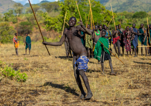 Suri tribe warrior dancing during a donga stick fighting ritual, Omo valley, Kibish, Ethiopia