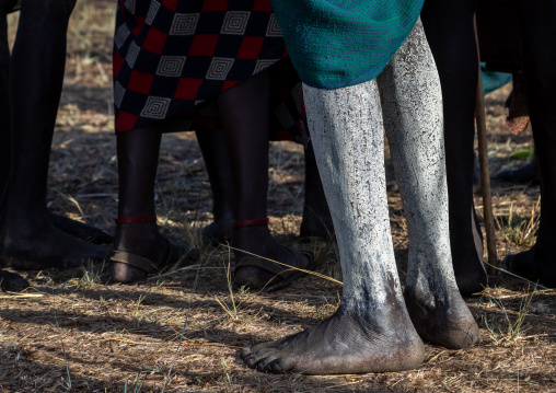 Suri tribe warrior legs with white make up during a donga stick fighting ritual, Omo valley, Kibish, Ethiopia
