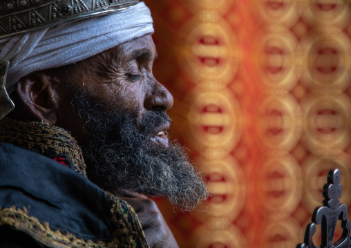 Ethiopian orthodox priest in nakuto lab rock church holding a cross, Amhara Region, Lalibela, Ethiopia