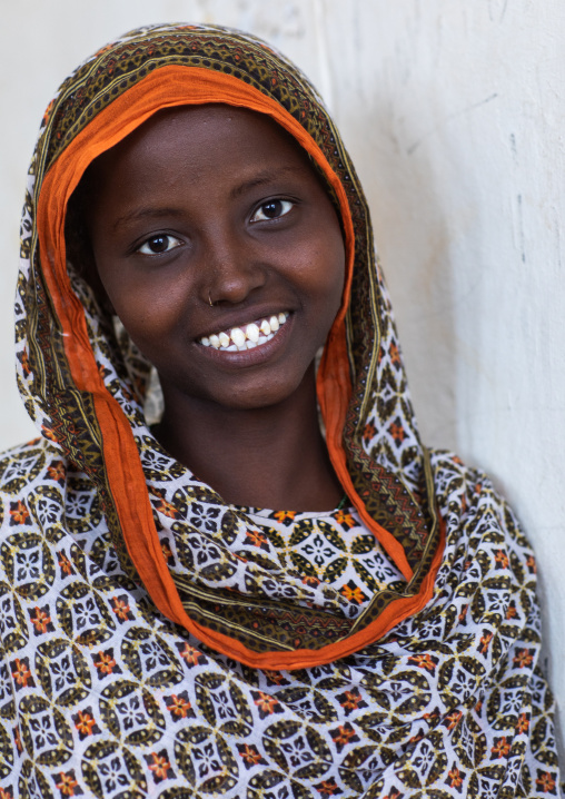 Portrait of a veiled smiling afar tribe girl with sharpened teeth, Afar Region, Afambo, Ethiopia
