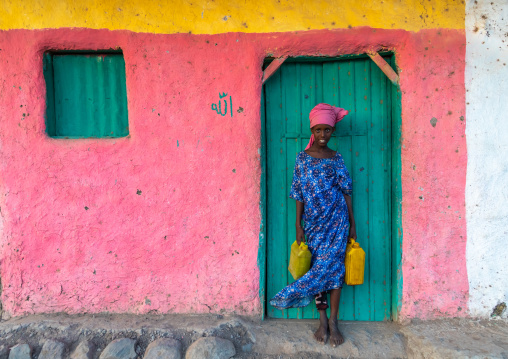 Portrait of an afar tribe girl with water jerricans, Afar Region, Afambo, Ethiopia
