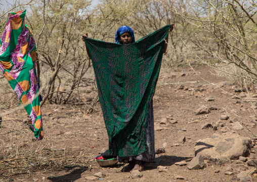 Somali woman drying clothes in an arid area, Afar Region, Gewane, Ethiopia