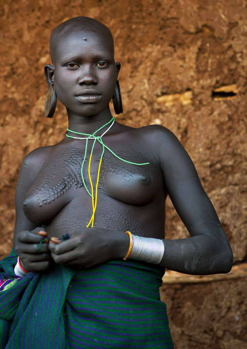 Suri tribe woman with traditional scarifications, Kibish, Omo valley, Ethiopia