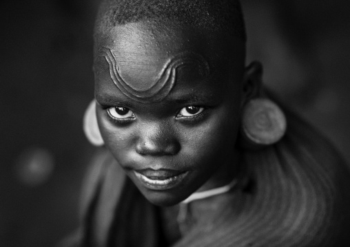 Suri tribe girl with facial scarifications, Kibish, Omo valley, Ethiopia