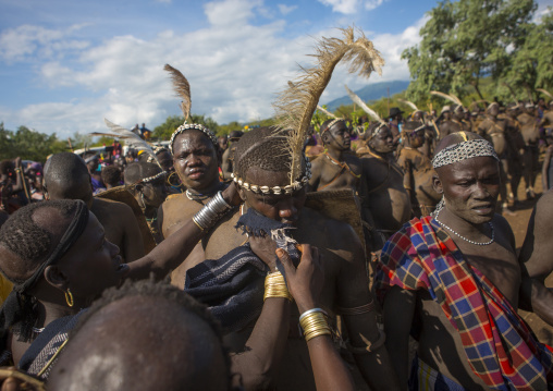 Bodi Tribe Woman Putting Water On The Face Of A Fat Man During Kael Ceremony, Hana Mursi, Omo Valley, Ethiopia