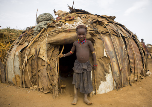 Dassanech Tribe Boy Standing In Front Of His House, Omorate, Omo Valley, Ethiopia