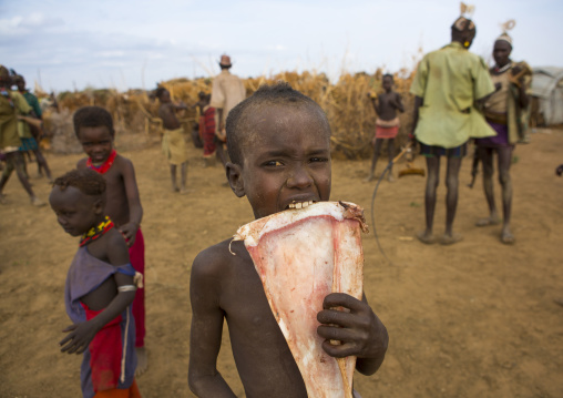 Dassanech Tribe Warriors Sharing Cow Meat During A Ceremony, Omorate, Omo Valley, Ethiopia