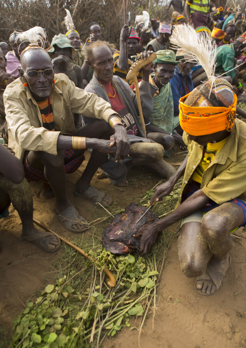 Dassanech Tribe Warriors Sharing Cow Meat During A Ceremony, Omorate, Omo Valley, Ethiopia