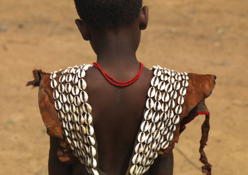 Back of a young tsemay girl top cloth made of cowry shells and skin, Omo valley, Ethiopia
