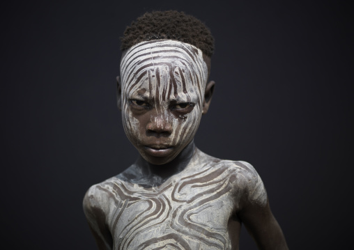 White Painted Face Of Young Mursi Boy Ethiopia