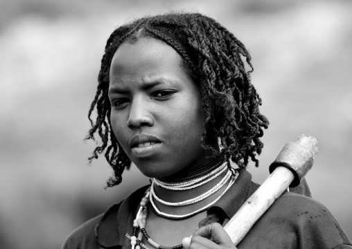 Black And White Portrait Of A Young Borana Tribe Lumberjack Woman Carrying An Axe, Yabello, Yabello, Omo Valley, Ethiopia