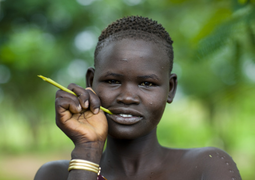 Portrait Of A Bodi Tribe Woman With Scarifications Chewing A Gima Stick, Omo Valley, Ethiopia