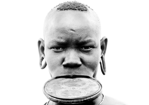 Black And White Portrait Of A Mursi Tribe Woman With Lip Plate And Extended Ear Lobes, Omo Valley, Ethiopia