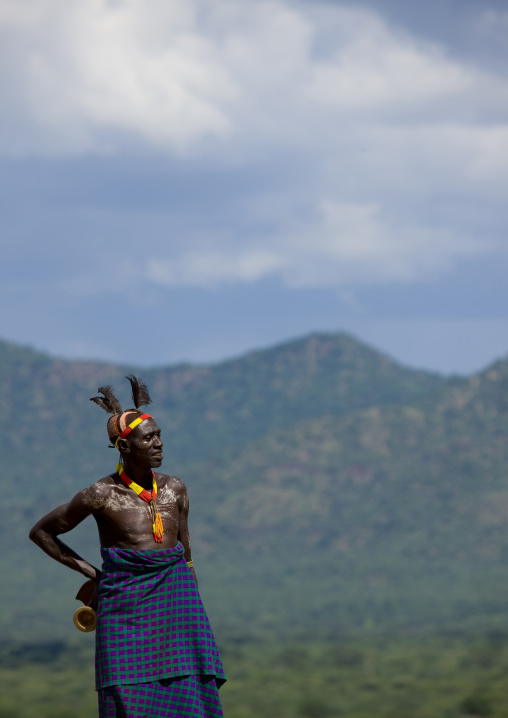 Portrait Of A Smiling Karo Tribe Man With Mud Bun And Headrest With Mountains In The Backgroung, Korcho Village, Omo Valley, Ethiopia