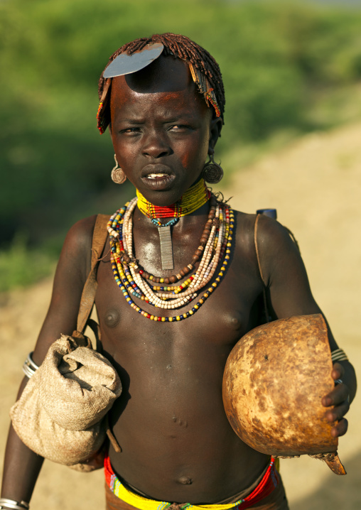 Portrait Of A Hamar Tribe Girl Holding A Calabash And Wearing A Bala On Her Head, Turmi, Omo Valley, Ethiopia