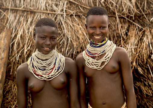 Portrait Of Two Young Karo Tribe Women With Toothy Smiles And Traditional Necklaces, Korcho Village, Omo Valley, Ethiopia