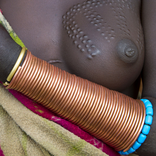 Bracelets and breast scarifications on a Suri woman, Kibish, Omo valley, Ethiopia
