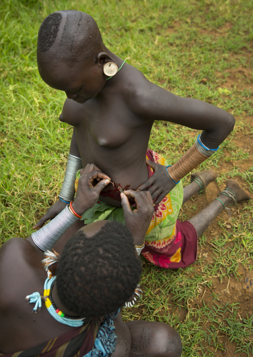 Suri tribe women during a scarification ceremony, Tulgit, Homo valley, Ethiopia