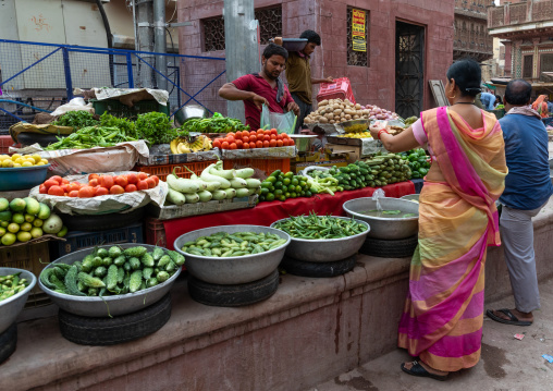 Indian man selling vegetables in a market, Rajasthan, Bikaner, India